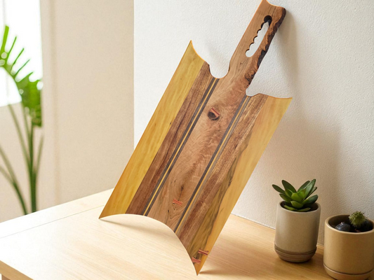Handmade charcuterie board with a live-edge handle.