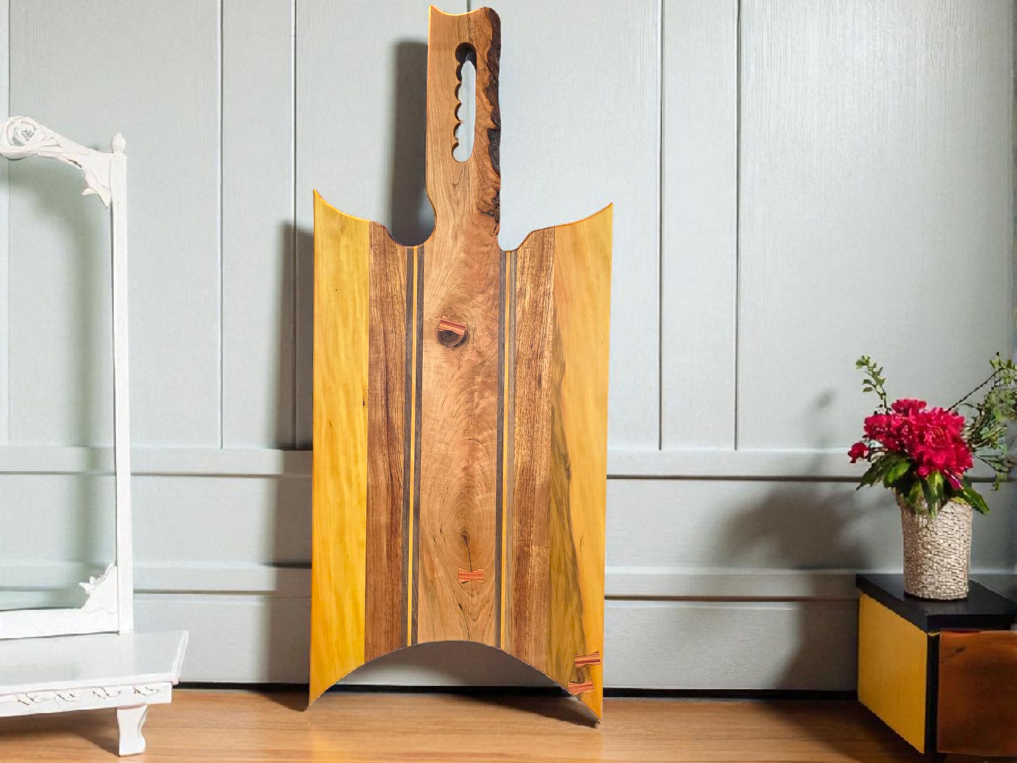 Handmade charcuterie board with a live-edge handle.