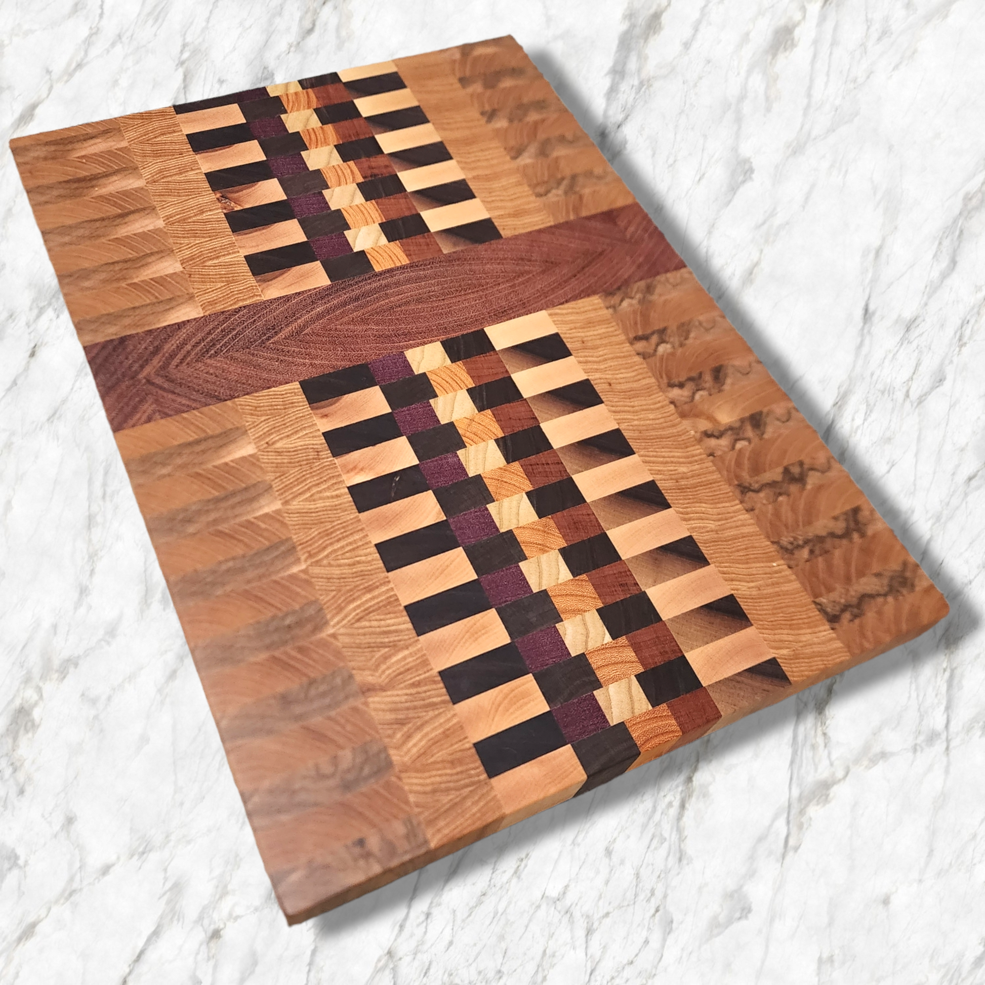 Veteran-owned brand luxury end grain cutting board handcrafted from exotic hardwoods with intricate geometric design