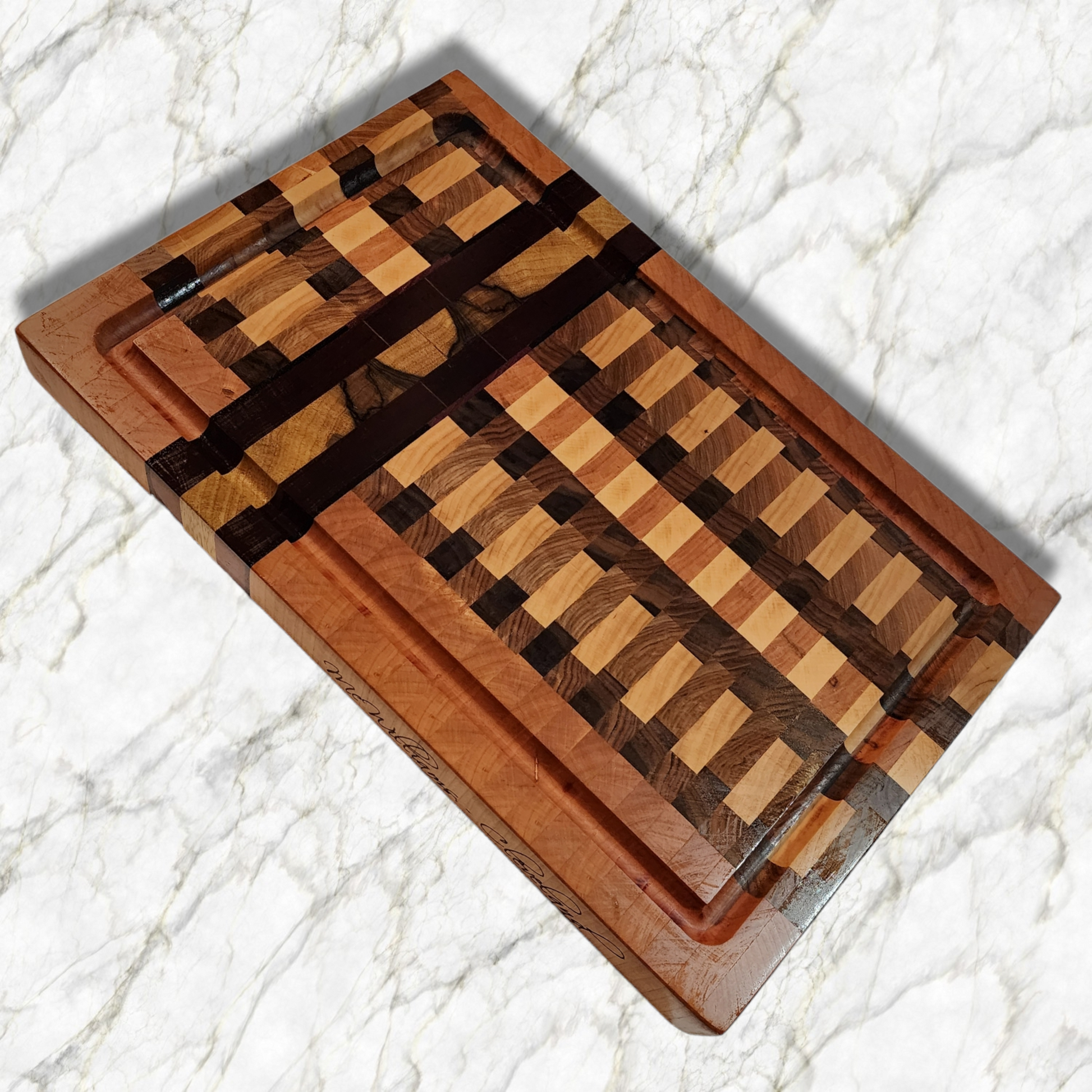 Veteran-owned brand luxury end grain cutting board handcrafted from exotic hardwoods with intricate geometric design