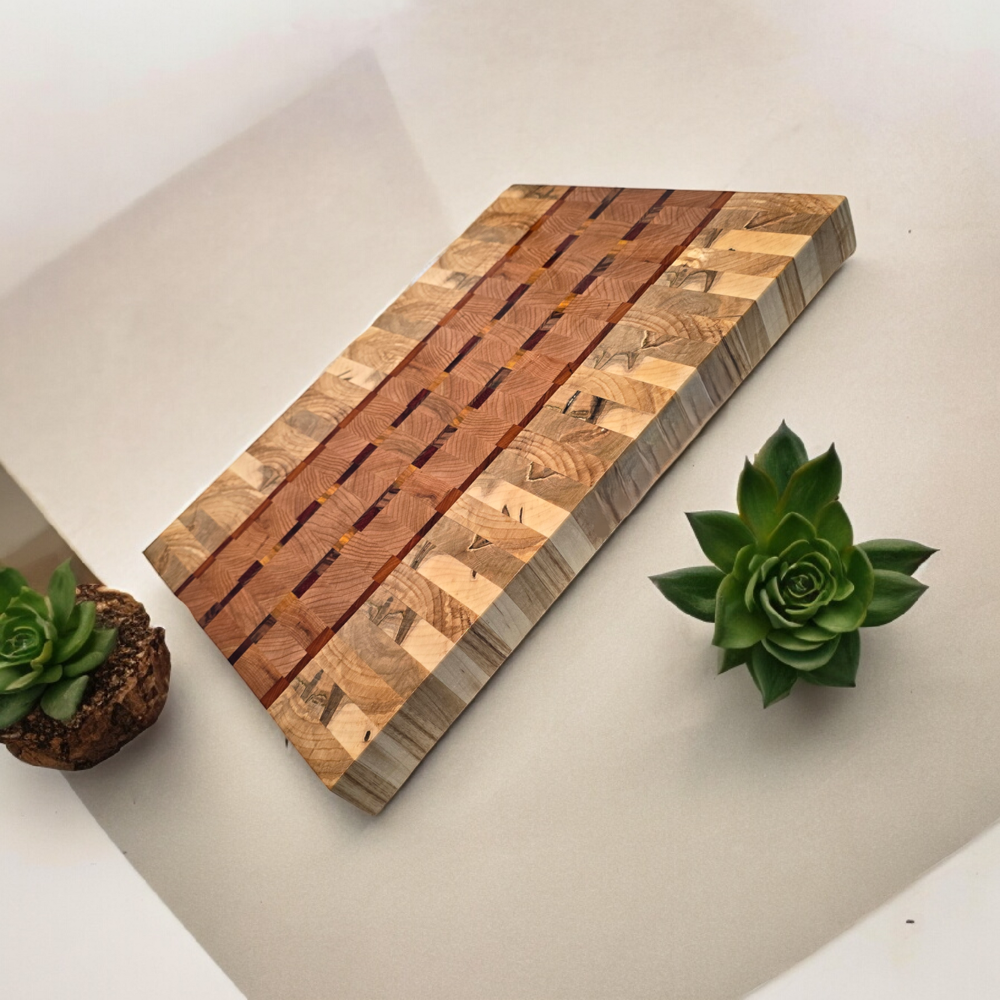Veteran-owned brand luxury end grain cutting board handcrafted from exotic hardwoods with intricate geometric design