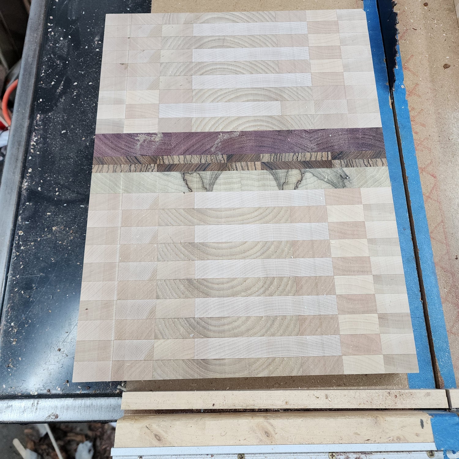 Wooden panel with a checkered pattern on a workbench